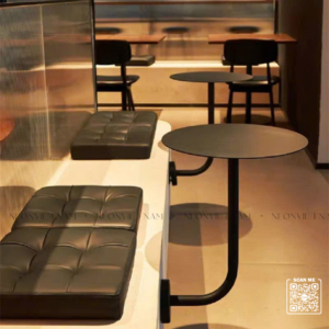 J-shaped decorative table for cafes and refreshment shops, attached to chairs.